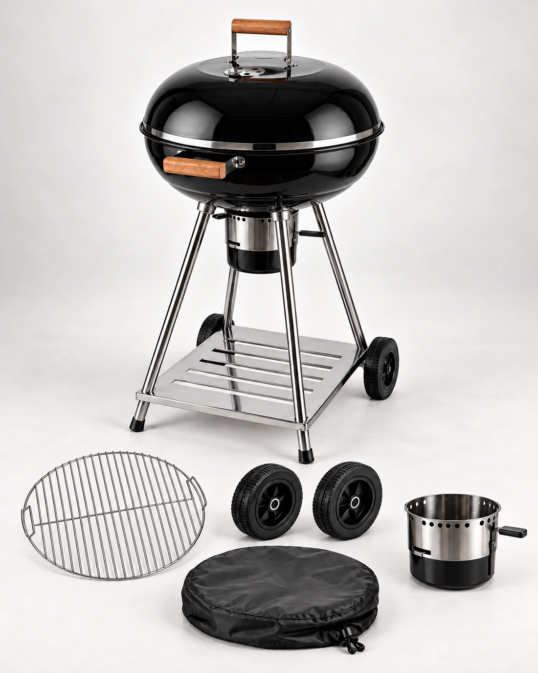 Vota Grills round charcoal grill with a replacement grilling grate, spare wheels, protective cover, and charcoal ash drawer component