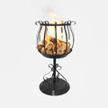 Black metal fire pit with burning logs on a white background